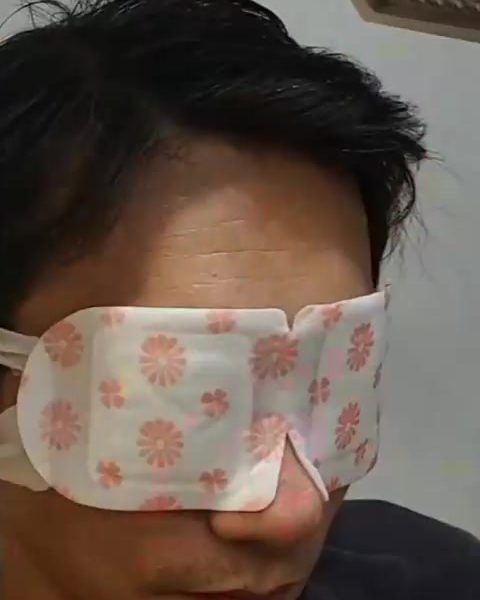 Guest relaxing with a warm eye-steam mask
